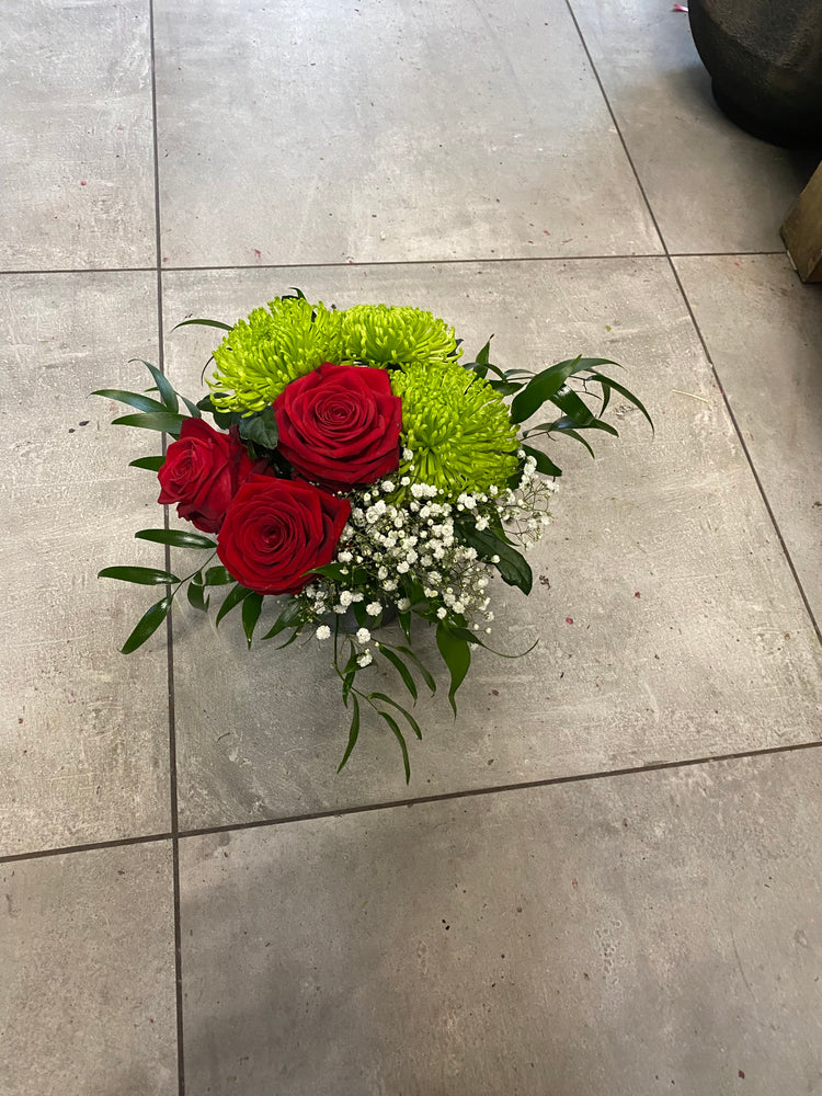 Shamrock and roses arrangement in a vase