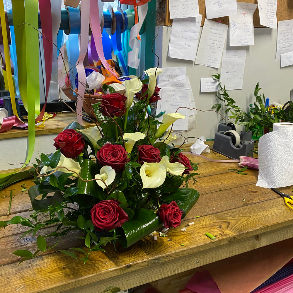 Calla lilies and roses arrangement